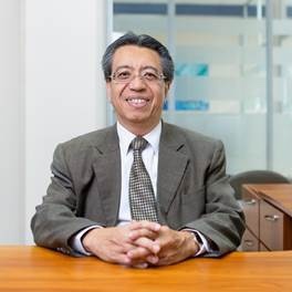 null A person in a suit sitting at a table smiling
Description automatically generated with low confidence